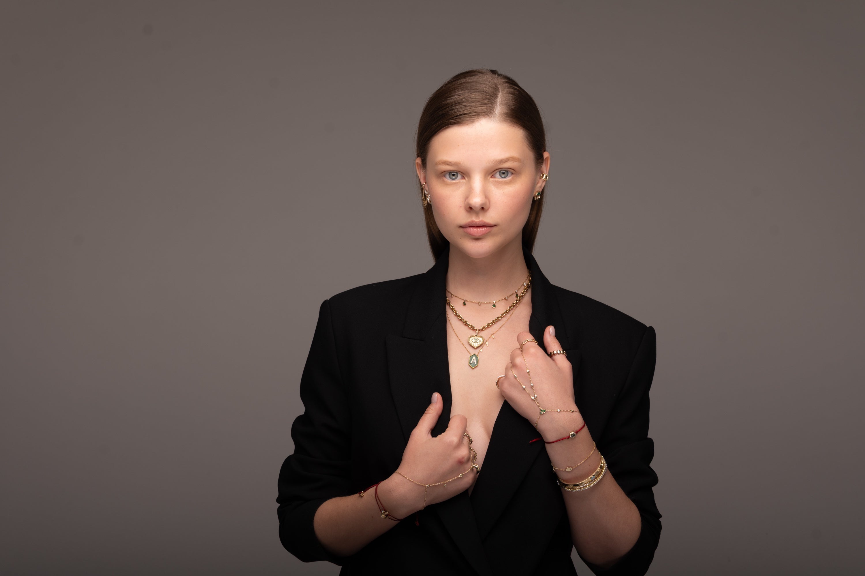 Heart and Initial necklaces, hand chains, rings and bangles styled together